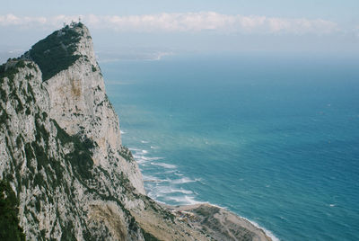 Rock of gibraltar by mediterranean sea against sky