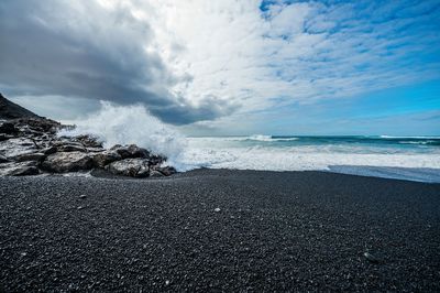 Scenic view of sea against cloudy sky