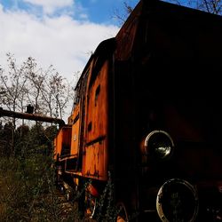 Cars on railroad tracks against sky