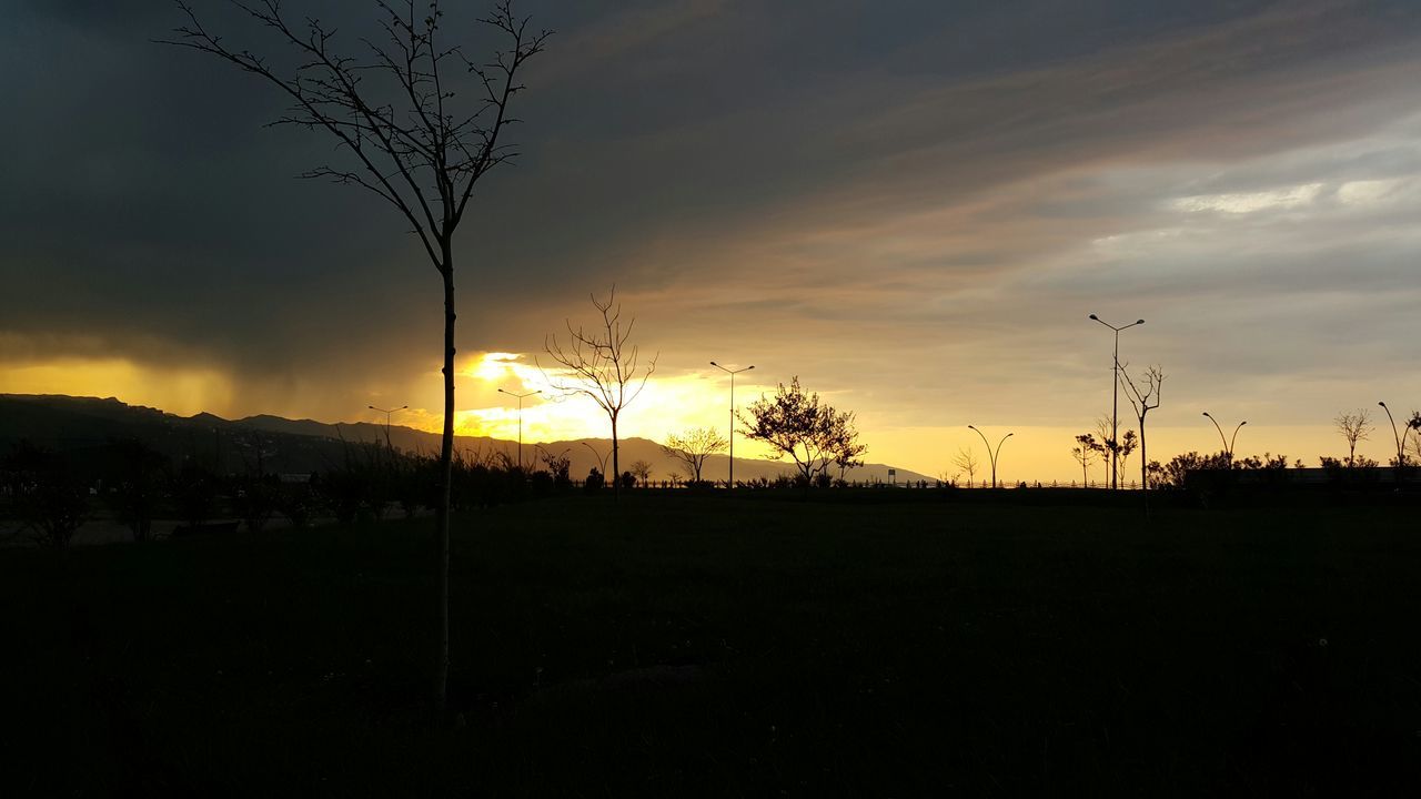 sunset, silhouette, landscape, tranquility, tranquil scene, sky, field, scenics, beauty in nature, nature, tree, idyllic, dark, bare tree, cloud - sky, sun, dusk, electricity pylon, non-urban scene, cloud