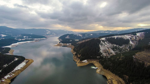 Aerial view of lake and mountains against sky