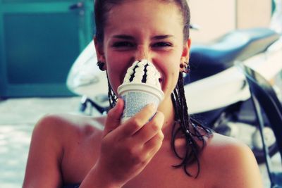 Close-up portrait of young woman drinking drink