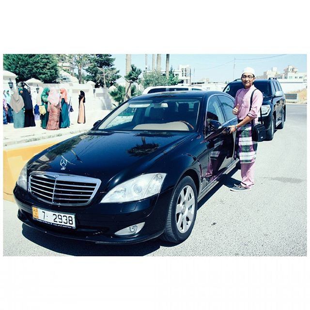 transfer print, auto post production filter, transportation, mode of transport, land vehicle, lifestyles, men, leisure activity, car, clear sky, travel, street, large group of people, person, day, sunlight, road, outdoors, motorcycle