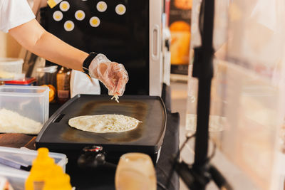 Midsection of woman preparing food in kitchen