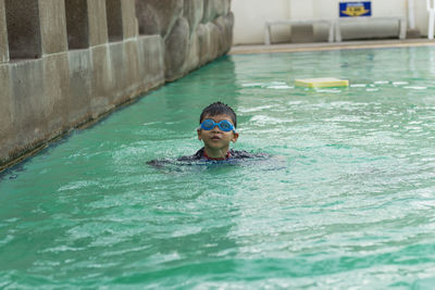 Boy swimming in pool