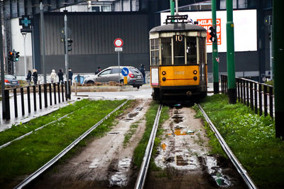 Puddle on railroad tracks against tramway during rainy season