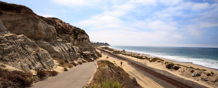 Panoramic view of road by sea against sky