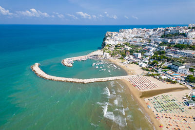 High angle view of sea and buildings against sky