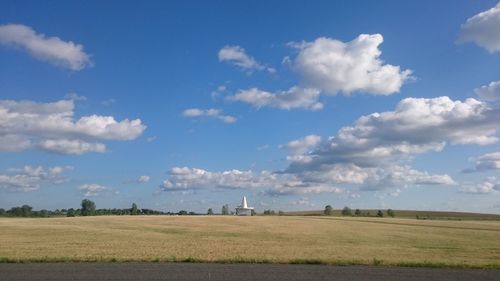 Scenic view of agricultural field against sky