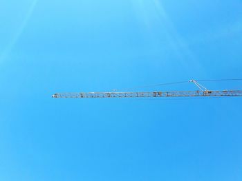 Low angle view of trees against clear blue sky