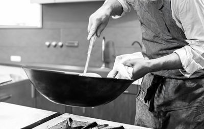 Midsection of man preparing food