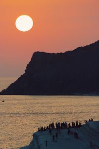 Scenic view of sea against orange sky