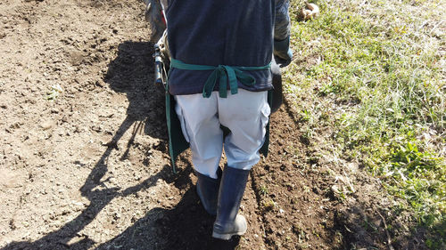 Low section of person standing on field