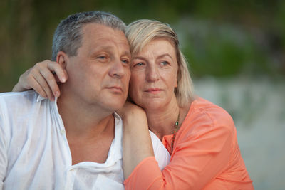 Thoughtful mature couple looking away outdoors