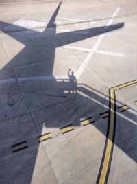 Shadow of airplane at airport runway