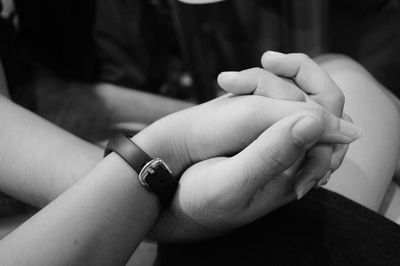 Close-up of couple holding hands