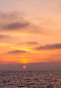 Scenic view of sea against romantic sky at sunset