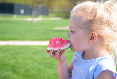 Close-up of girl with ice cream against blurred background