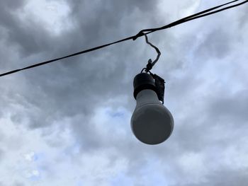 Low angle view of light bulb against sky