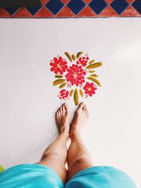 Low section of woman standing by flowering plants