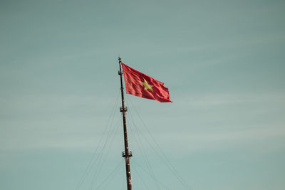 Low angle view of flag on pole against sky