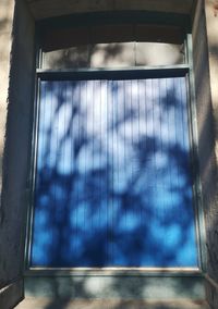 Low angle view of glass window against building