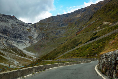 Road amidst mountains against sky