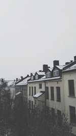 Houses in city against clear sky