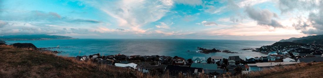 Panoramic view of sea and buildings against sky