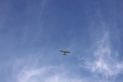 Low angle view of airplane flying in sky