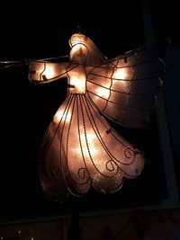 Low angle view of illuminated chandelier hanging from ceiling