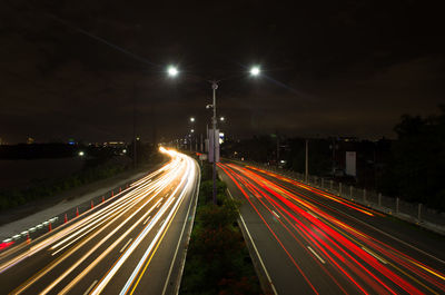 High angle view of light trails on road at night