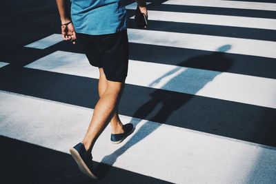 Low section of people walking on road