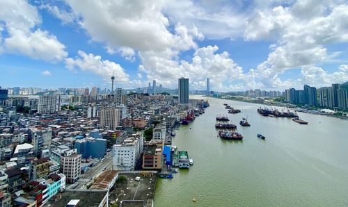 High angle view of buildings by sea against sky