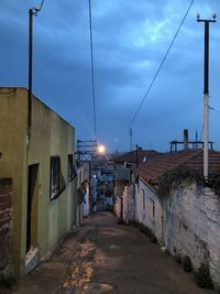 Street amidst buildings against sky in city