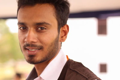 Close-up portrait of smiling young man