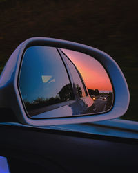 Reflection of car on side-view mirror