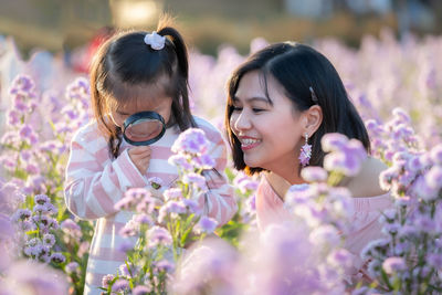 Close-up of woman with pink flowering plants