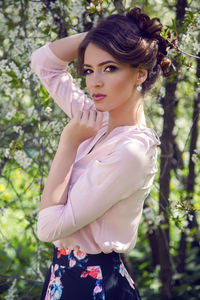 Portrait of a young girl brown hair with make-up in the cherry sakura pink ,white in a blue skirt