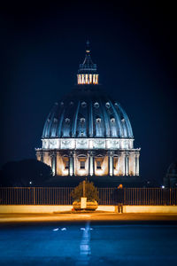 Illuminated building against sky at night