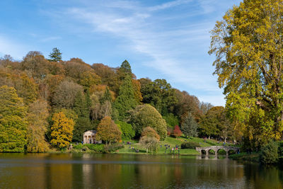 View of the autumn colours around the lake at stourhead gardens in wiltshire.