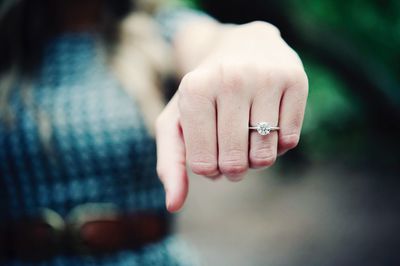 Close-up of diamond ring in human finger