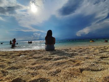 People on beach against sky