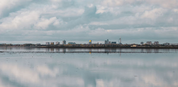Signature buildings of portsmouth from a distance, with the spinnaker tower, from hayling island, uk