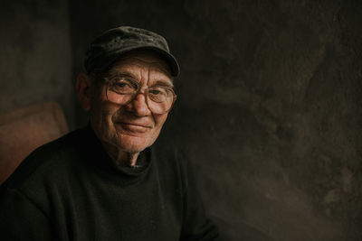 Portrait of young man standing against wall