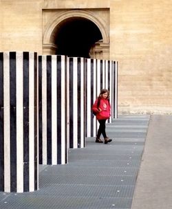 Full length of woman standing on railing