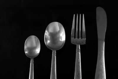 Low angle view of lighting equipment against black background