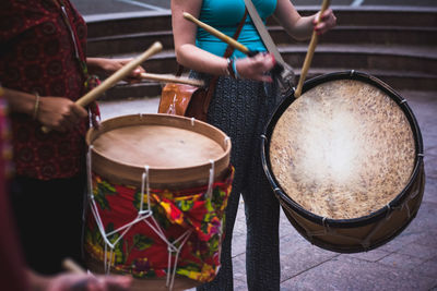 Cropped hand of man playing drum