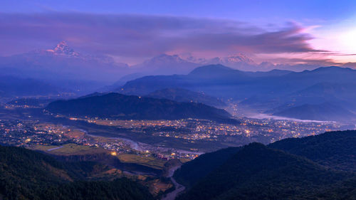 Scenic view of mountains against sky at sunset