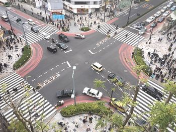 High angle view of moving vehicles on road junction in city